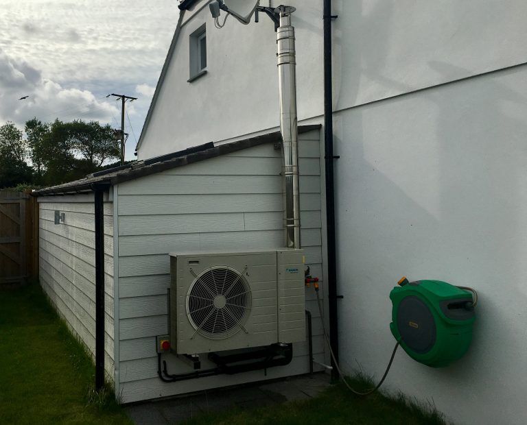 Heat pump beside a house