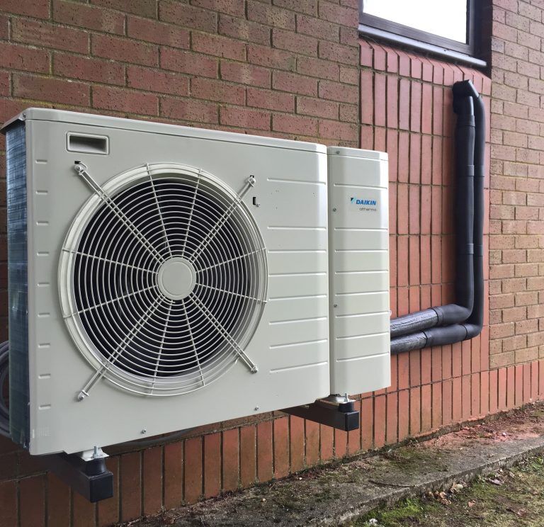 Daikin air source heat pump mounted on a brick wall