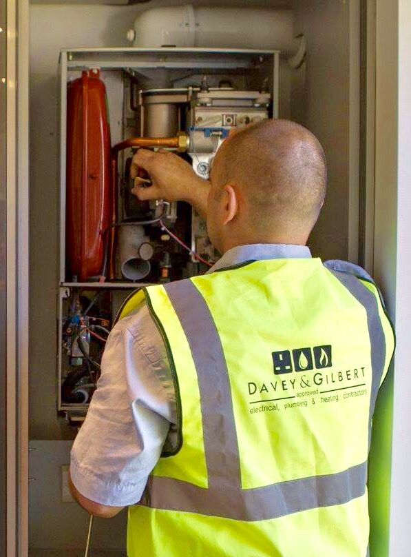 Gas Safe engineer inspecting a boiler