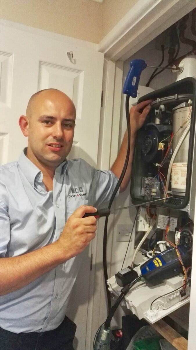 Gas Safe engineer inspecting a boiler