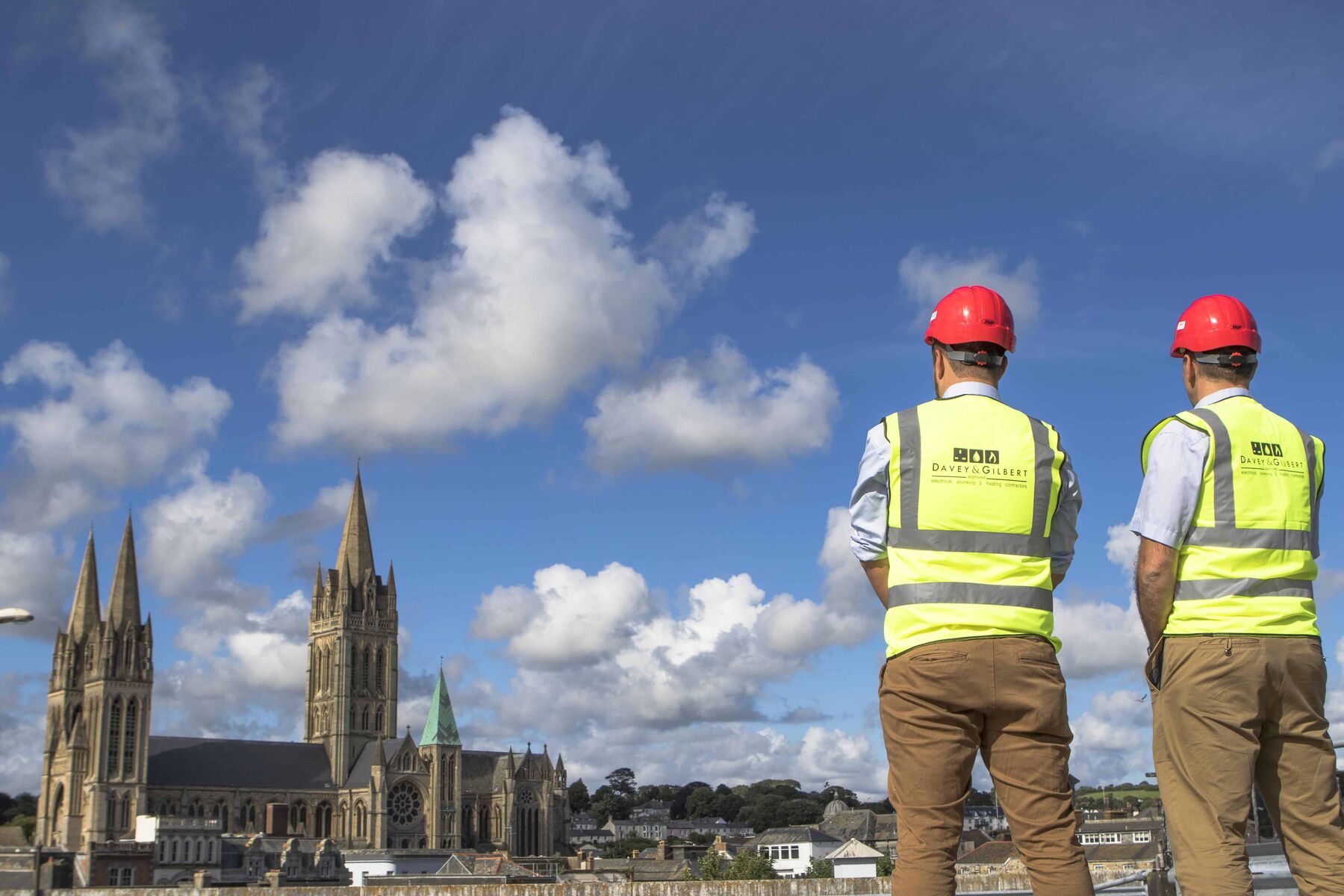 Two Davey & Gilbert engineers in hi-vis in front of Truro Cathedral