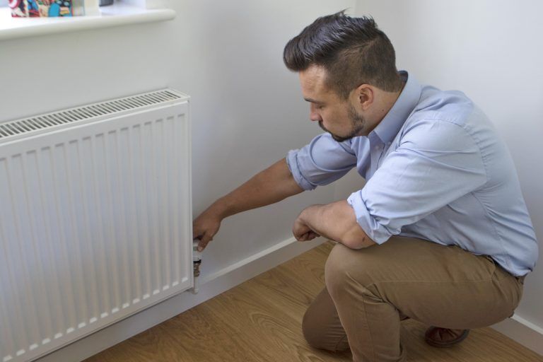 Engineer fitting a radiator