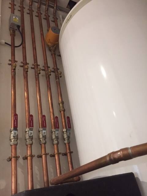 Pipework beside a hot water cylinder