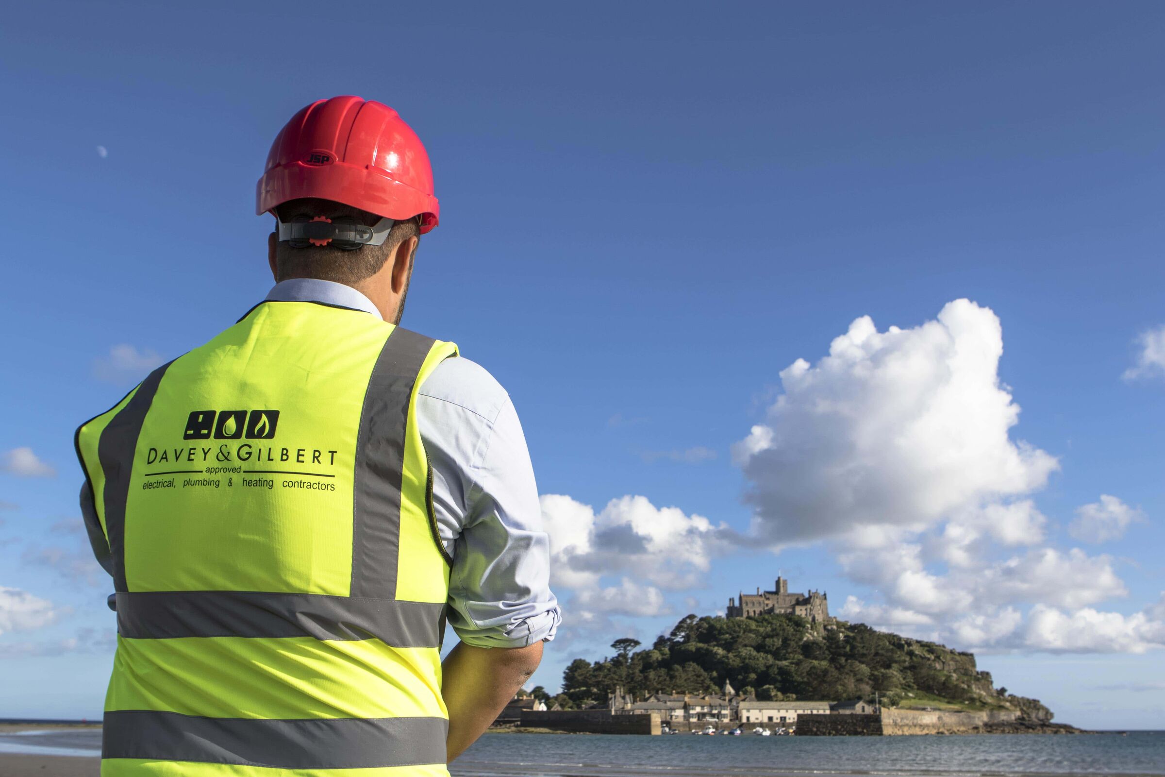 Davey & Gilbert engineer in a hard hat looking out towards St Michael's Mount