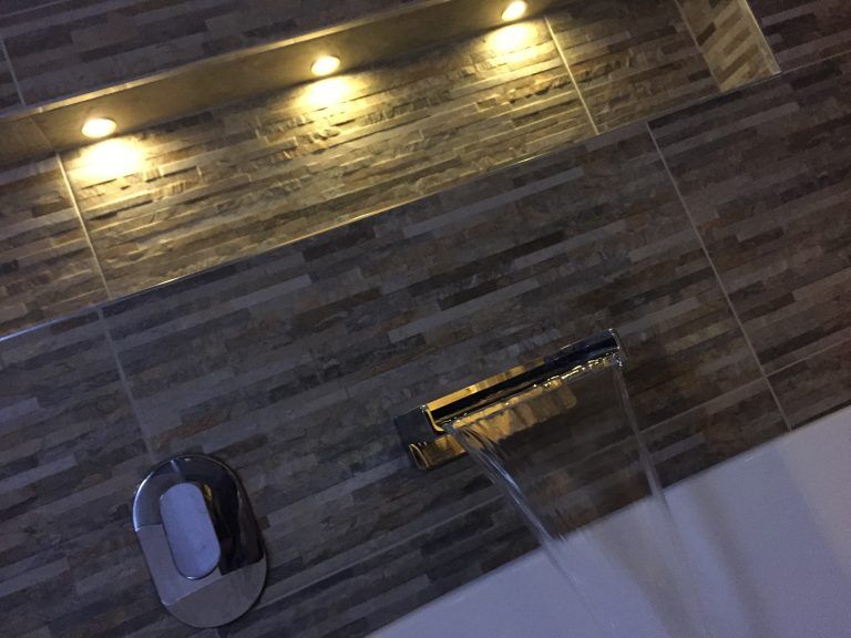 Wall mounted bath filler with feature lighting