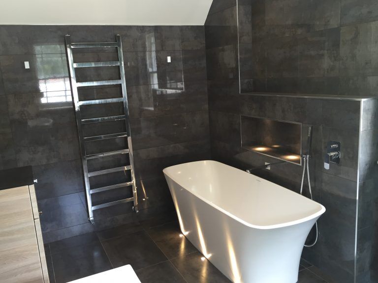 Luxury bathroom with freestanding bath and heated towel rail